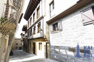an alley in an old city with a building at Ubilla by Kaiberri Inmo in Hondarribia