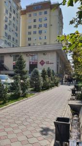 a cobblestone street in front of a large building at Arbat apartment in the center city in Bishkek