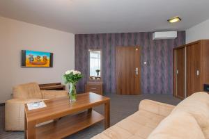 a living room with a couch and a table at Hotel Esperanto in Świdnica