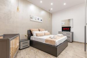 a bedroom with a bed and a crib at [The historical center of Palermo] La Dolce Vita in Palermo