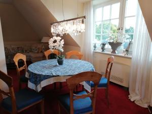 a dining room with a table and chairs and a window at Appartment Obergeschoß in Bad Zwischenahn