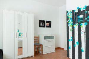 a room with a mirror and a dresser and a bedroom at Apartman Mia in Palit