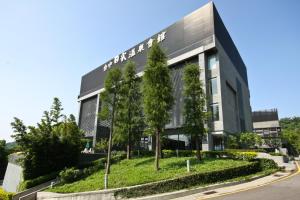 an office building with trees in front of it at The Sun Hot Spring & Resort in Taichung