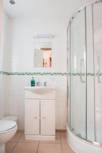 a bathroom with a shower and a sink and a toilet at The Talbot Arms in Lyme Regis