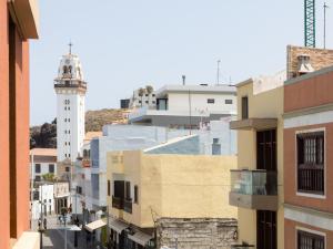 a city street with a lighthouse in the distance at Live Basilica Candelaria Beach & Balcony in Candelaria +27 photos