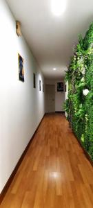 an empty room with a hard wood floor and plants at KLCC/Pavilion Avatar Theme 5BR in Kuala Lumpur