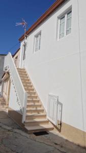 a white building with stairs on the side of it at Piso de Laura en primera planta in Lariño