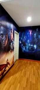 a room with a movie mural on the wall at KLCC/Pavilion Avatar Theme 5BR in Kuala Lumpur