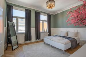 a bedroom with a bed and a large window at Amazing Royal Suite in Helsingør