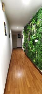 an empty hallway with a large green wall at KLCC/Pavilion Avatar Theme 5BR in Kuala Lumpur