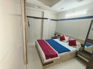 a bedroom with a bed and a walk in shower at HOTEL SAI PRABHU INN in Shirdi