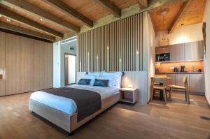 a bedroom with a large bed and a kitchen at Studio na Stolbi in Ljubljana
