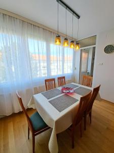 a dining room with a table with chairs at Apartman Iadera in Zadar