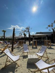 a group of lawn chairs on a sandy beach at Skyfall Rooms in Eisenstadt