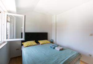 מיטה או מיטות בחדר ב-Little Max Apartment