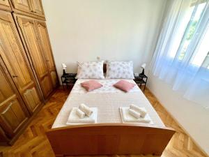 a bedroom with a bed with two pillows on it at Apartment Troisa in Kaštela