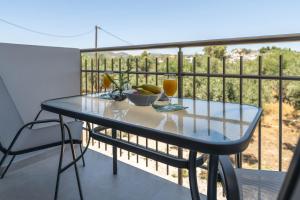 a blue table on a balcony with a view at Demiani House in Lardos