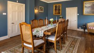 a dining room with a table and chairs at Winstone Glebe in Cirencester
