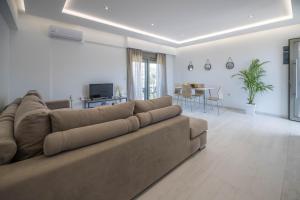 a living room with a couch and a dining room at Demiani House in Lardos