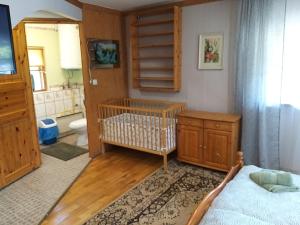a bedroom with a crib and a bathroom at Villa Maia in Papsaare