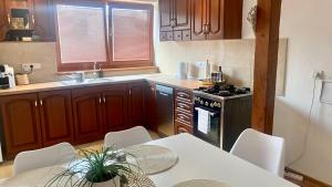 a kitchen with a table and chairs and a stove at Sunny Attic Apartment in Zvolen
