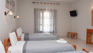 Postel nebo postele na pokoji v ubytování Aris Junior Studios Neo Klima Skopelos