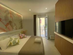 a bedroom with a large bed and a flat screen tv at Bullerjanos in Olbia