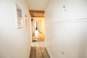 a room with white cabinets and a hallway at Ferienwohnung Königsleiten 63 - Top 18 in Königsleiten +8 photos