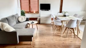 a living room with a couch and a table at Sunny Attic Apartment in Zvolen