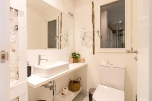 a white bathroom with a sink and a toilet at Salazar by Staynnapartments in Bilbao