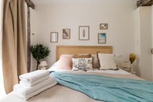 a bedroom with a bed with towels on it at Salazar by Staynnapartments in Bilbao