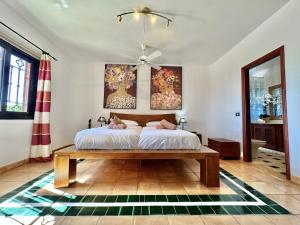 a bedroom with a bed and a table at Tropical Garden Finca in Guía de Isora