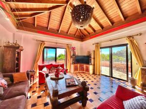 a living room with a couch and a table at Tropical Garden Finca in Guía de Isora