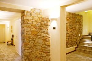 uma parede de pedra num corredor com uma escada de pedra em La Valletta Relais em Bérgamo