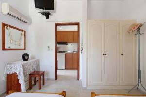 a living room with a table and a kitchen at Areti Orfeas Apartment 6 in Vasilikos +15 photos