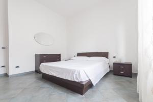 a bedroom with a large bed and two night stands at The Breeze Way in Piombino