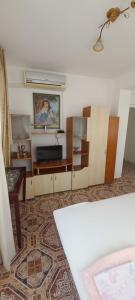 a living room with a couch and a tv at Casa Branca in Sozopol
