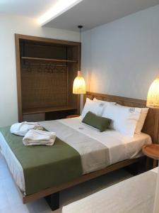 a bedroom with a bed with a laptop on it at Azzure Luxury Suites in Potos