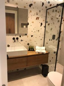 a bathroom with a sink and a mirror at Azzure Luxury Suites in Potos