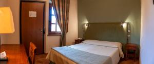 A bed or beds in a room at Hotel La Fattoria