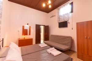 a living room with a bed and a couch at Kathy's Apartments in Rhodes Town