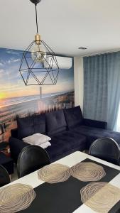 a living room with a blue couch and chairs at Domki pod gwieździstym niebem in Zastań +80 photos