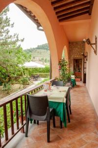 a patio with a table and chairs on a balcony at Hotel Ristorante La Fattoria in Spoleto