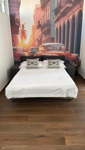 1 dormitorio con 2 camas y una pintura de una calle en HAVANA HOUSE, en Bari