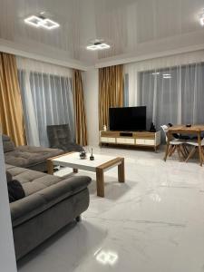 a living room with a couch and a coffee table at Koya Tower by Lake Mamaia in Mamaia