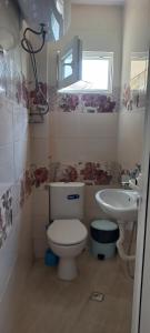 a bathroom with a toilet and a sink at Casa Branca in Sozopol +19 photos
