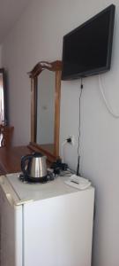 a flat screen tv on top of a refrigerator at Casa Branca in Sozopol