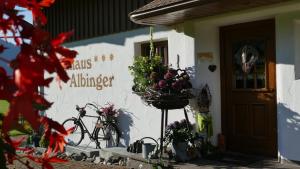 a building with flowers on the side of it at Albingers Landhaus in Balderschwang