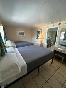 a bedroom with a large bed and a table at Breezy Palms Resort in Islamorada