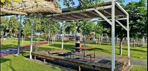 a picnic table under a pavilion in a park at דירת 2 חדרים בטיילת בת ים in Bat Yam +20 photos